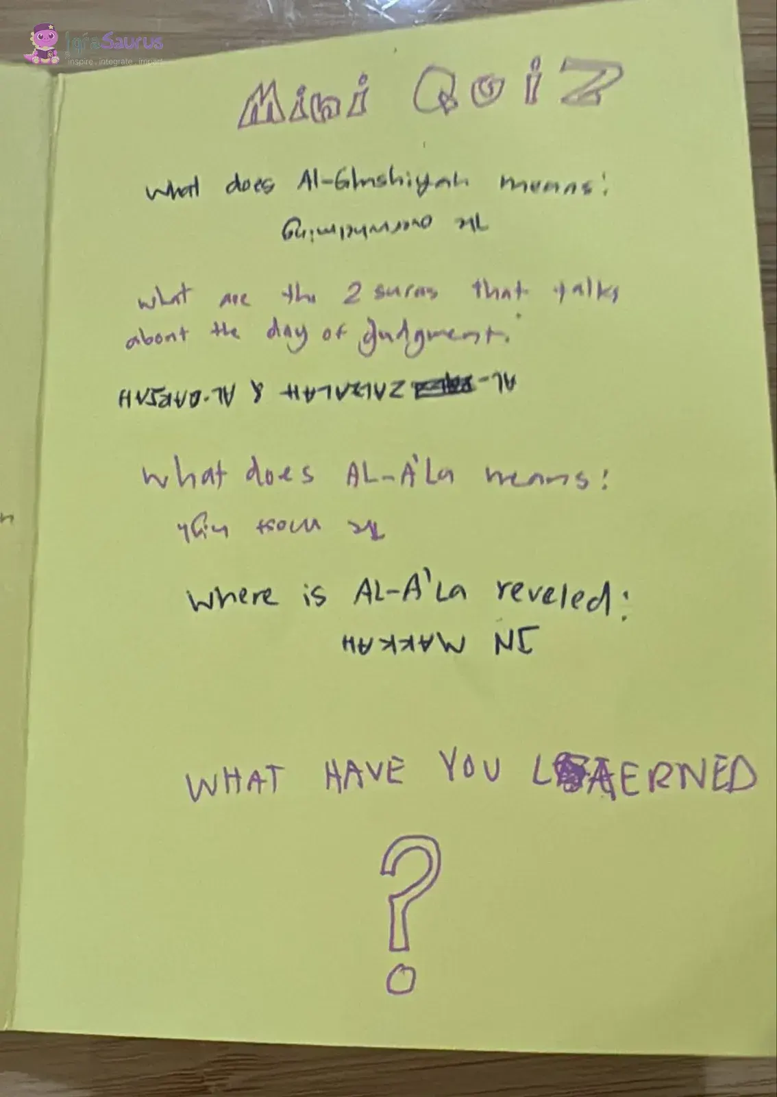 A quiz page with four questions, each answer written upside down beneath it, and a large question mark at the bottom.