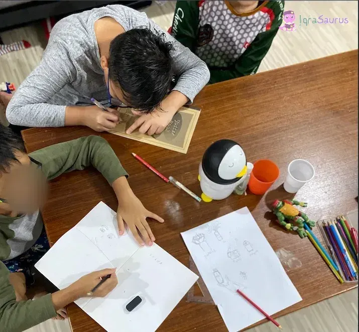 Our children's cousins journaling at the table with pencils and coloured pencils